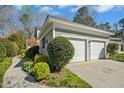 Attached two-car garage featuring well-maintained landscaping and a charming exterior at 1309 Langdon Pl, Pittsboro, NC 27312