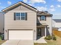 Inviting home showcasing a two-car garage and neat landscaping around the front entrance at 1445 Lombar St, Raleigh, NC 27610