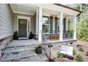 Inviting front porch with stone steps, white columns, and a glimpse of stylish exterior at 150 Green Haven Blvd # 67, Youngsville, NC 27596