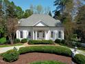 Charming single story home featuring white exterior, shutters, and professionally landscaped yard at 1925 Banbury Rd, Raleigh, NC 27608