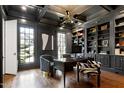 Sophisticated home office with built-in shelving, hardwood floors, and natural light from multiple windows at 1925 Banbury Rd, Raleigh, NC 27608
