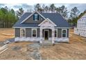 Beautiful one-story home showcasing detailed trim and a covered entryway under construction at 195 Duncan Creek Rd # 123, Lillington, NC 27546