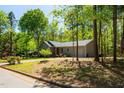 Charming single-story home with a well-maintained lawn and mature trees at 2 Edgestone Pl, Chapel Hill, NC 27517