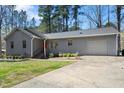 Inviting one-story home featuring a red door and an attached garage at 2 Edgestone Pl, Chapel Hill, NC 27517