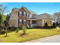 Charming two-story home with a landscaped yard, stone accents and covered entryway at 2006 Prairie Ridge Ct, Fuquay Varina, NC 27526