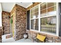 Inviting front porch with stone accents, black shutters, and space for seating at 2006 Prairie Ridge Ct, Fuquay Varina, NC 27526
