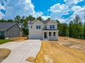 Charming two-story home with a covered porch and a two-car garage, set on a partially cleared lot at 217 Duncan Creek Rd # 124, Lillington, NC 27546