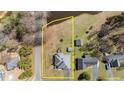 Aerial view of a single Gathering home with a pond and clearly marked property lines at 248 Brookfield Cir, Sanford, NC 27330