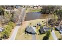 Aerial view of a single Gathering home with a large pond in the backyard at 248 Brookfield Cir, Sanford, NC 27330