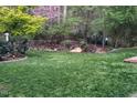 Large, well-maintained backyard with lush green grass and mature trees at 2812 Dahlgreen Rd, Raleigh, NC 27615