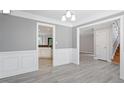 Bright dining room with gray walls, crown molding and vinyl floors at 2812 Dahlgreen Rd, Raleigh, NC 27615
