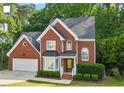 Traditional two-story brick home with mature trees and manicured lawn at 2812 Dahlgreen Rd, Raleigh, NC 27615