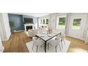 Open-concept living and dining area with large windows and hardwood floors at 296 Beacon Dr, Pittsboro, NC 27312