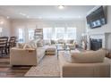 Cozy living room featuring a comfortable sectional, fireplace, and plenty of natural light at 3144 Star Gazing Ln, Durham, NC 27703
