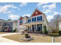 Beautiful two-story home with a well-maintained lawn, landscaped garden, and covered front porch at 3557 S Beaver Ln, Raleigh, NC 27604
