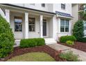 Inviting, two-story painted brick home with manicured lawn and a cozy covered entryway at 4026 Overcup Oak Ln, Cary, NC 27519
