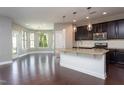 Open kitchen featuring granite countertops, stainless steel appliances, and pendant lighting at 4026 Overcup Oak Ln, Cary, NC 27519