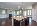 Open kitchen featuring granite countertops, stainless steel appliances, and pendant lighting at 4026 Overcup Oak Ln, Cary, NC 27519
