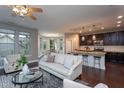 Open-concept living room with hardwood floors, connecting kitchen and dining areas at 4026 Overcup Oak Ln, Cary, NC 27519