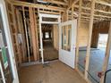 Unfinished entryway featuring a partially installed front door and stud walls at 452 Duncan Creek Rd # 156, Lillington, NC 27546