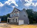 Side exterior view of a two-story home, featuring an attached garage at 452 Duncan Creek Rd # 156, Lillington, NC 27546