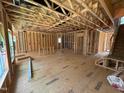 View of the spacious unfinished living room with exposed framing and subfloor at 452 Duncan Creek Rd # 156, Lillington, NC 27546