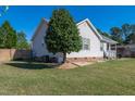 Exterior view of a well maintained home with green grass and a charming side garden at 46 Trawick Pl, Clayton, NC 27520