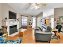 Cozy living room featuring a fireplace, wood floors, and comfortable seating at 46 Trawick Pl, Clayton, NC 27520