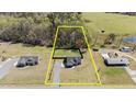 Aerial view of property showcasing lot size, landscaping, and proximity to woods at 511 Mcarthur Rd, Broadway, NC 27505