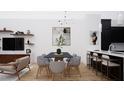 Open dining area featuring modern lighting, a dining table, and stylish decor at 512 Gordon St # 404, Durham, NC 27701