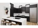 Modern kitchen with black cabinets, white countertops, and stainless steel appliances at 512 Gordon St # 404, Durham, NC 27701