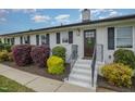 Charming front entrance with painted stairs, manicured bushes, and a decorative door wreath at 5121 Leesville Rd, Durham, NC 27703