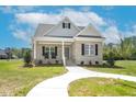 Charming single-story brick home with a welcoming front porch and well-manicured lawn on a sunny day at 55 Glasgow, Rocky Mount, NC 27804