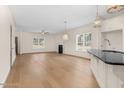 Open-concept living room with hardwood floors and a fireplace, with kitchen view at 55 Glasgow, Rocky Mount, NC 27804