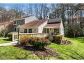 Charming home featuring a welcoming walkway and front porch, complemented by well-maintained landscaping and mature trees at 5932 Whitebud Dr, Raleigh, NC 27609