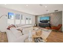 Bright living room with large windows, hardwood floors, and stylish decor at 6926 Leesville Rd, Raleigh, NC 27613