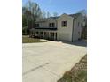 Wide view of a two-story home with a welcoming front porch, two-car garage and long driveway at 6932 Buckhorn Duncan Rd, Holly Springs, NC 27540