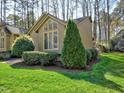Well-kept lawn with landscaping, showcasing the exterior of the attractive single-story home at 8008 Grey Oak Dr, Raleigh, NC 27615
