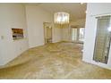 Open living room with light carpet, chandelier and access to a backyard patio at 8008 Grey Oak Dr, Raleigh, NC 27615