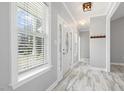 Bright foyer with marble tile flooring, a decorative front door, and natural light at 808 Cross Link Dr, Angier, NC 27501