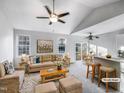 Bright living room with vaulted ceilings, ceiling fans, and access to the dining area at 101 Adams Peak Ln, Garner, NC 27529