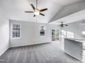 Open living area with vaulted ceiling, ceiling fans, slider, and abundant natural light at 101 Adams Peak Ln, Garner, NC 27529