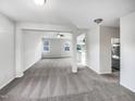 Spacious living area featuring new carpet, large windows and an open-concept design at 101 Adams Peak Ln, Garner, NC 27529