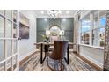 Home office with neutral walls, chandelier, modern desk, and decorative rug with a window view at 1010 Red Roses Ave, Durham, NC 27703