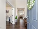 Inviting foyer with dark wood flooring, view to a naturally lit office, and a view into the living room at 1040 Lippincott Rd, Durham, NC 27703