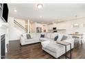 Open-concept living room showcases sleek floors, a modern fireplace, and seamlessly connects to the kitchen at 1040 Lippincott Rd, Durham, NC 27703