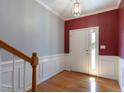 Inviting foyer with hardwood floors, crown molding, and a front door with sidelights at 106 Madison Square Ln, Cary, NC 27513