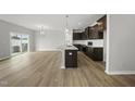 Bright, open living space features hardwood floors, large windows, and flows into the modern kitchen area at 108 Ripple Way # 319, Clayton, NC 27520