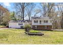 Two-story home with white siding, blue shutters, and a well-maintained front lawn at 1101 Driftwood Dr Dr, Siler City, NC 27344