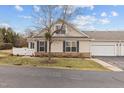 Two-story home with attached garage, showcasing well-maintained landscaping and a paved driveway at 1159 Blue Bird Ln, Wake Forest, NC 27587